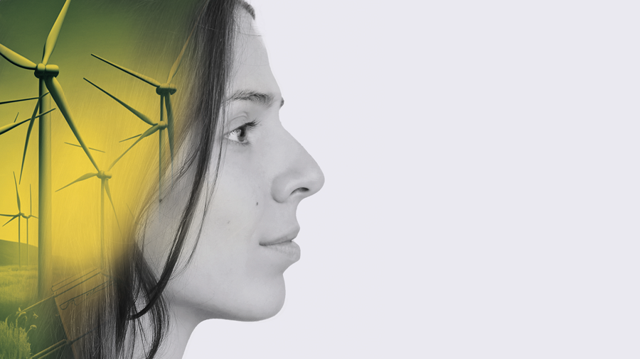 Young woman's face with wind turbines