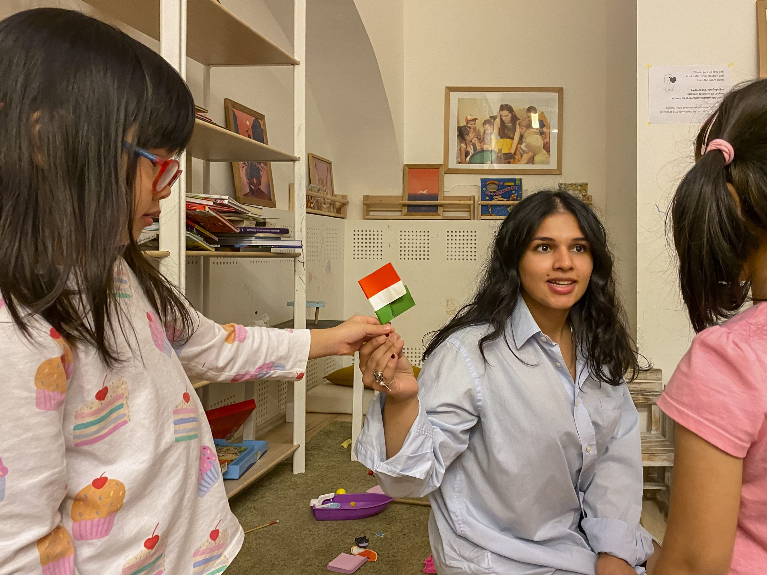  A woman and a little girl holding a small paper flag.