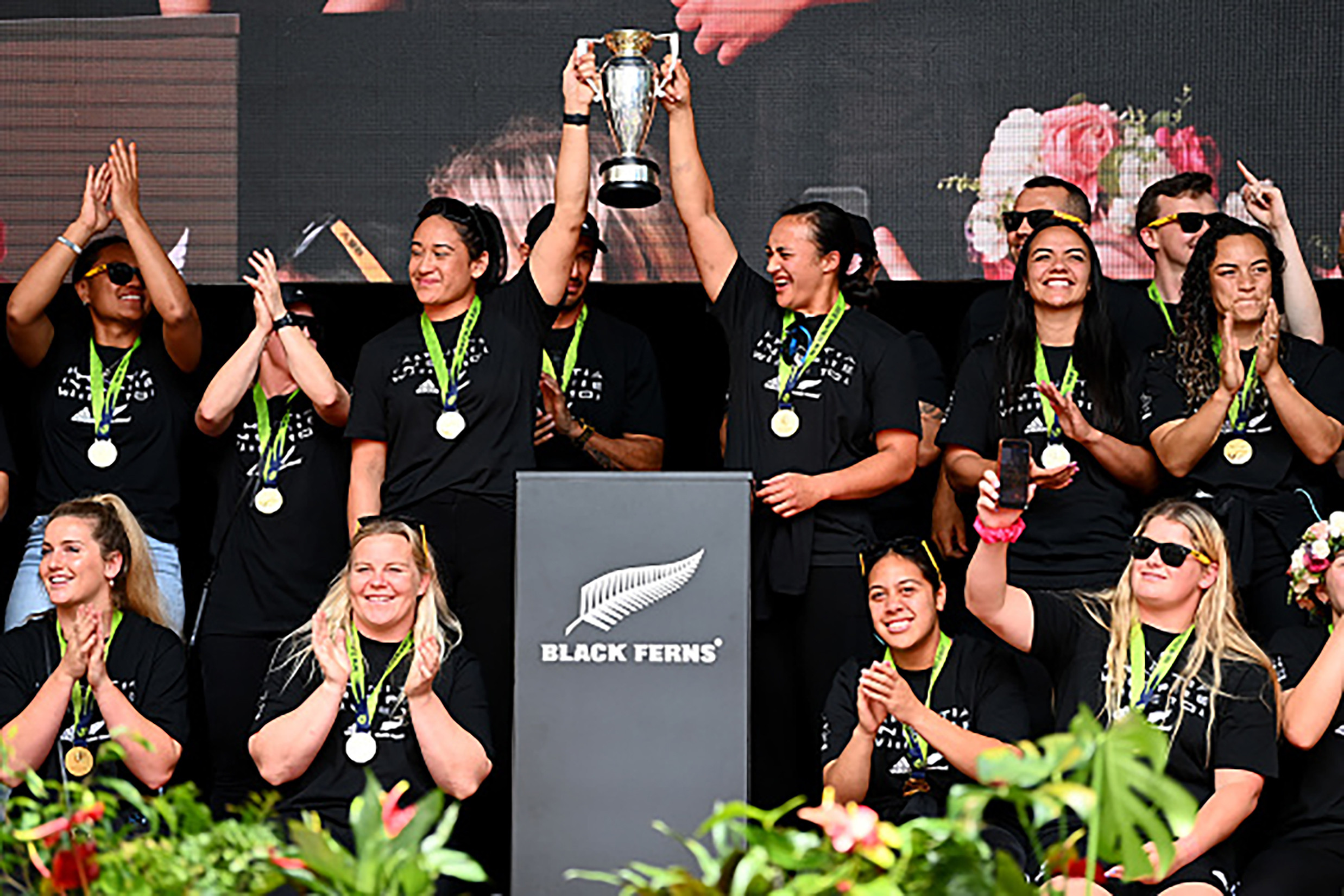 a rugby team celebrating a trophy