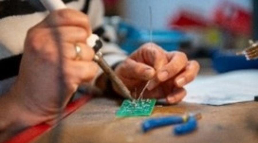 Picture of hands working on a microchip